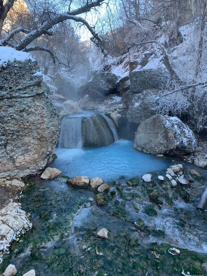 Turquoise soaking pool below a waterfall at Fifth Water Hot Springs near Spanish Fork, Utah