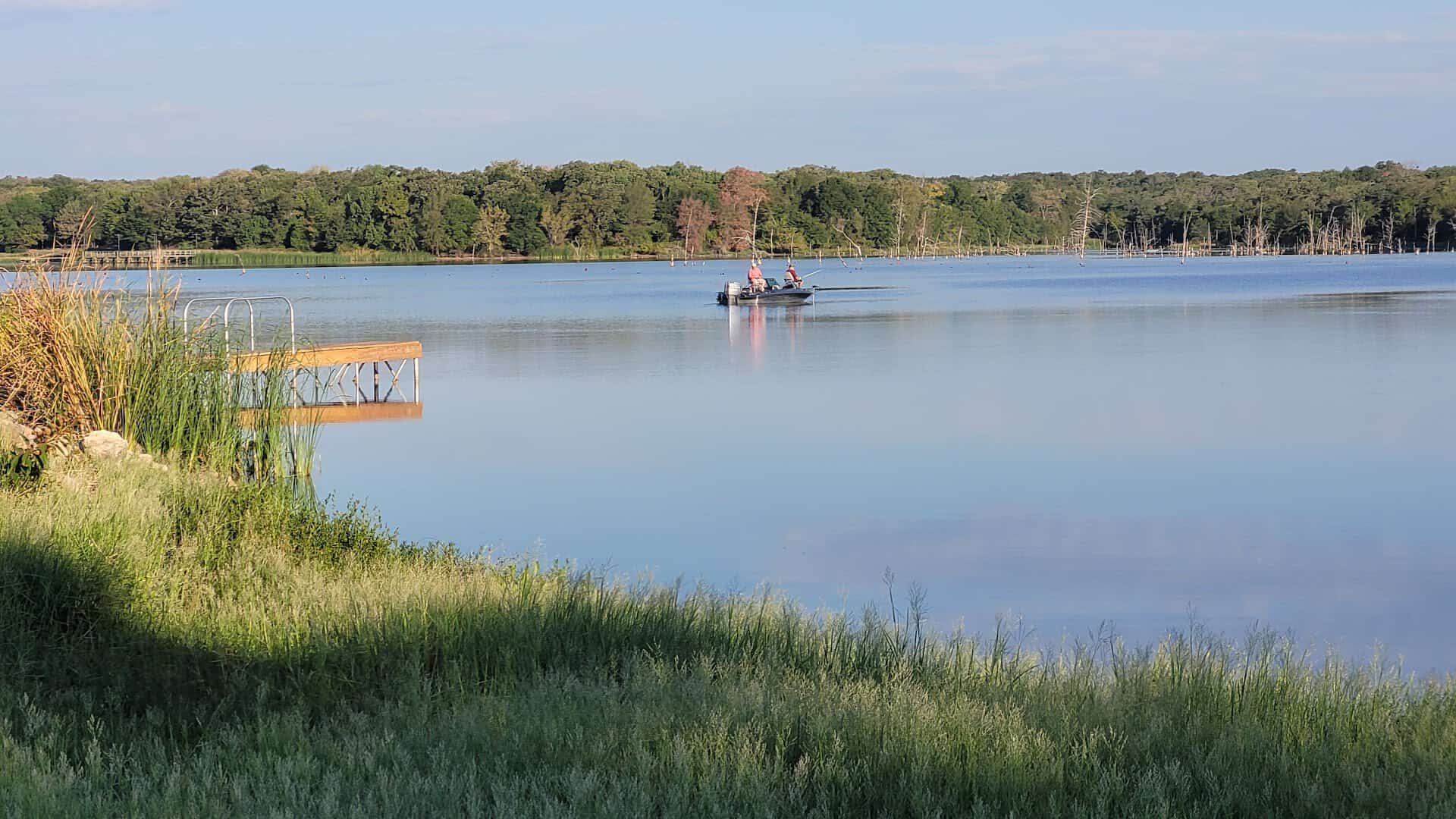 Small fishing boat on the calm no-wake lake at Purtis Creek State Park