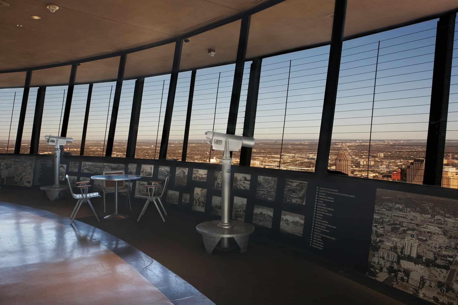 Telescopes and historic photo panels on the Flags Over Texas observation deck at the Tower of the Americas