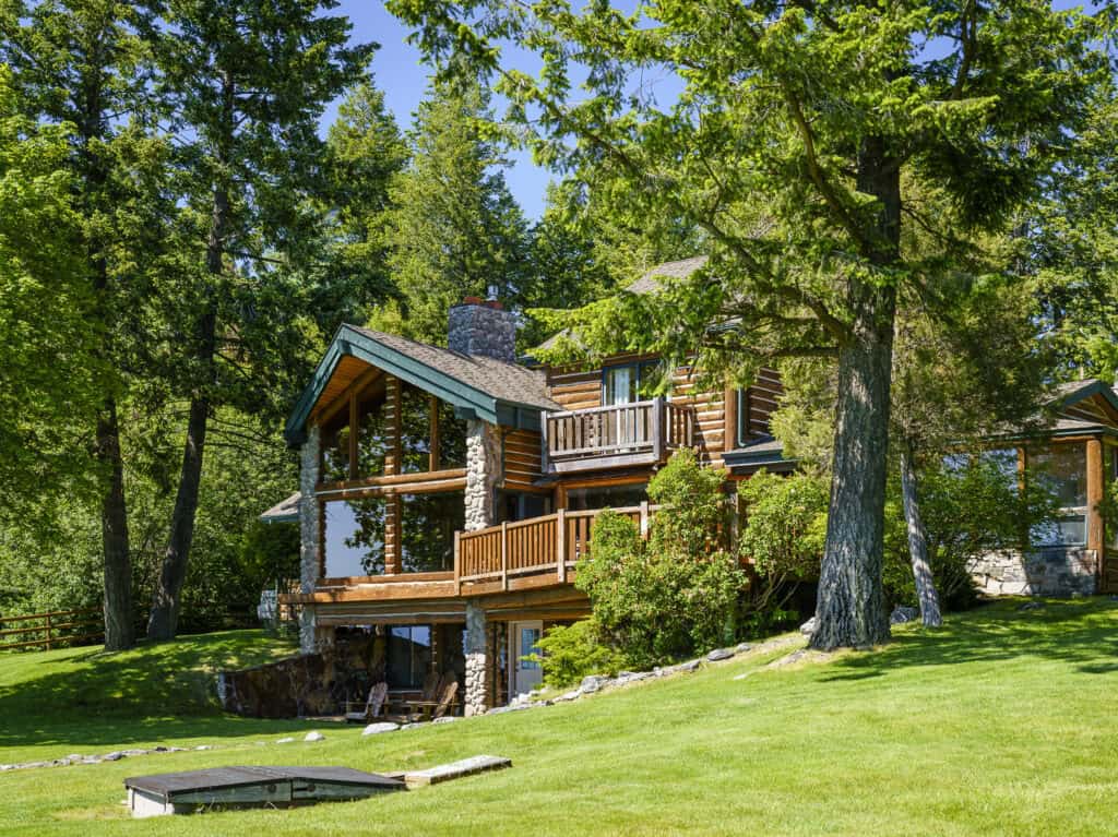 Log cabin among pines at Flathead Lake Lodge in Bigfork, Montana