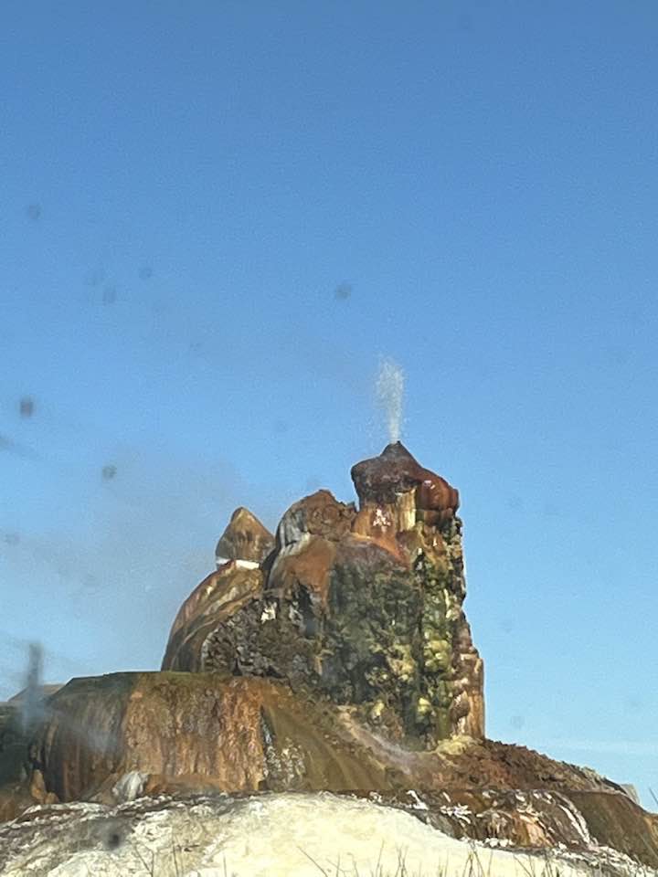 Fly Geyser's colorful terraced mineral mound spouting water near Gerlach, Nevada