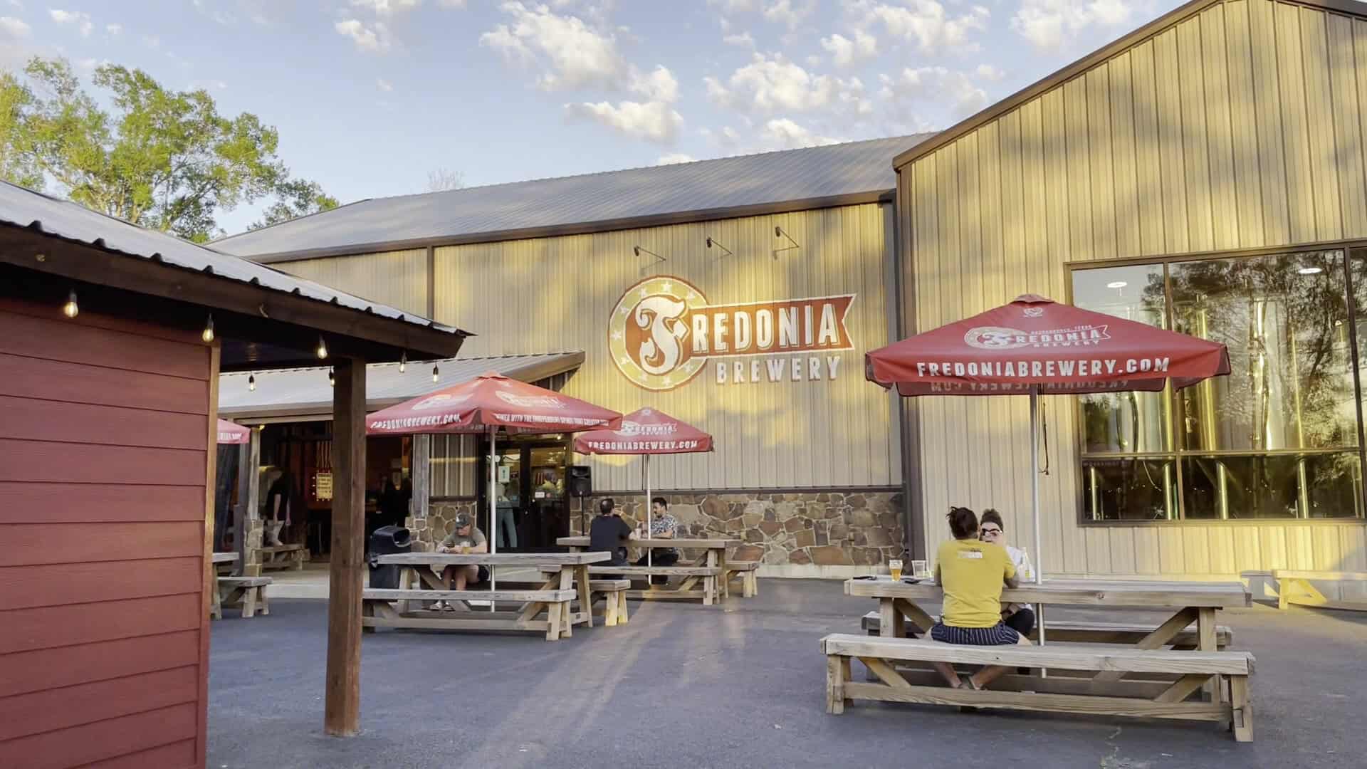 Beer garden patio with picnic tables at Fredonia Brewery in Nacogdoches, Texas