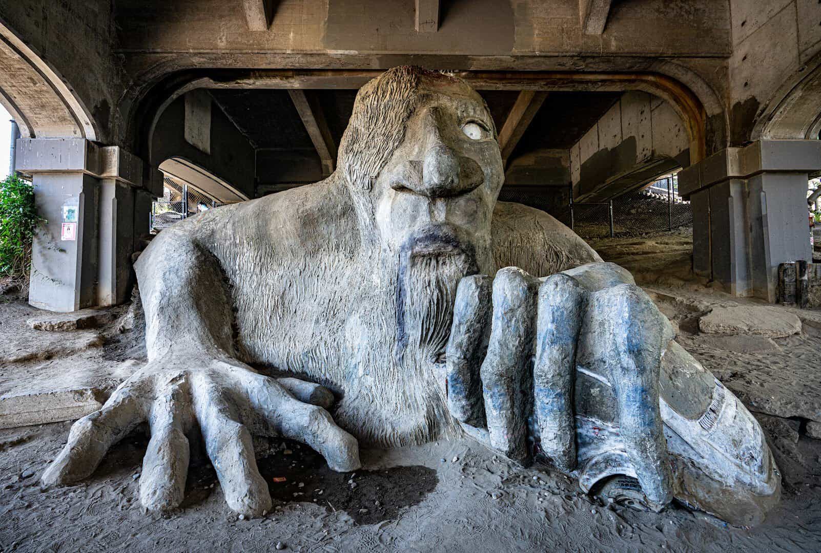 The Fremont Troll clutching a Volkswagen Beetle under the Aurora Bridge in Seattle, Washington