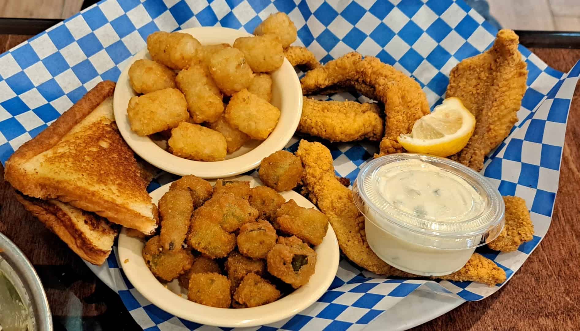 Fried catfish with bowls of fried okra and fried squash, Texas toast and tartar sauce at Richter's Antler Cafe in Spring Branch, Texas