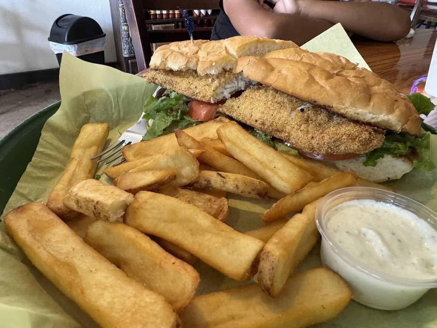 Fried catfish po boy sandwich with thick-cut fries at Fish Shack in Plano, Texas