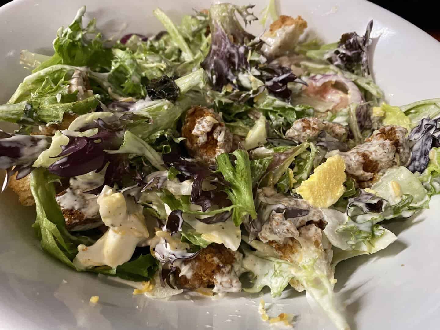 Fried chicken salad with greens at Mel's Diner in Mingus, Texas