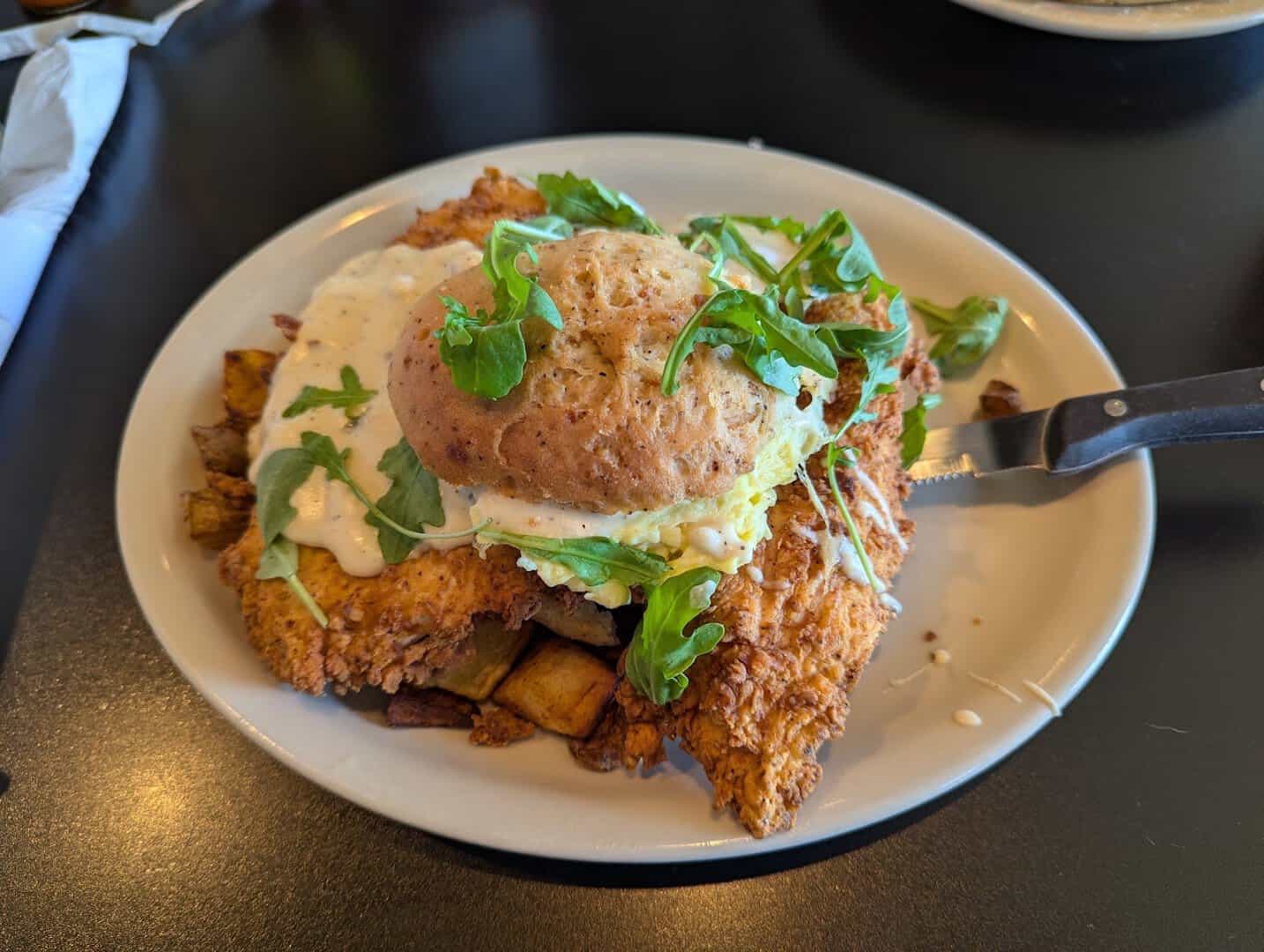 Fried chicken sandwich over breakfast potatoes at Jonathon's Diner in Dallas