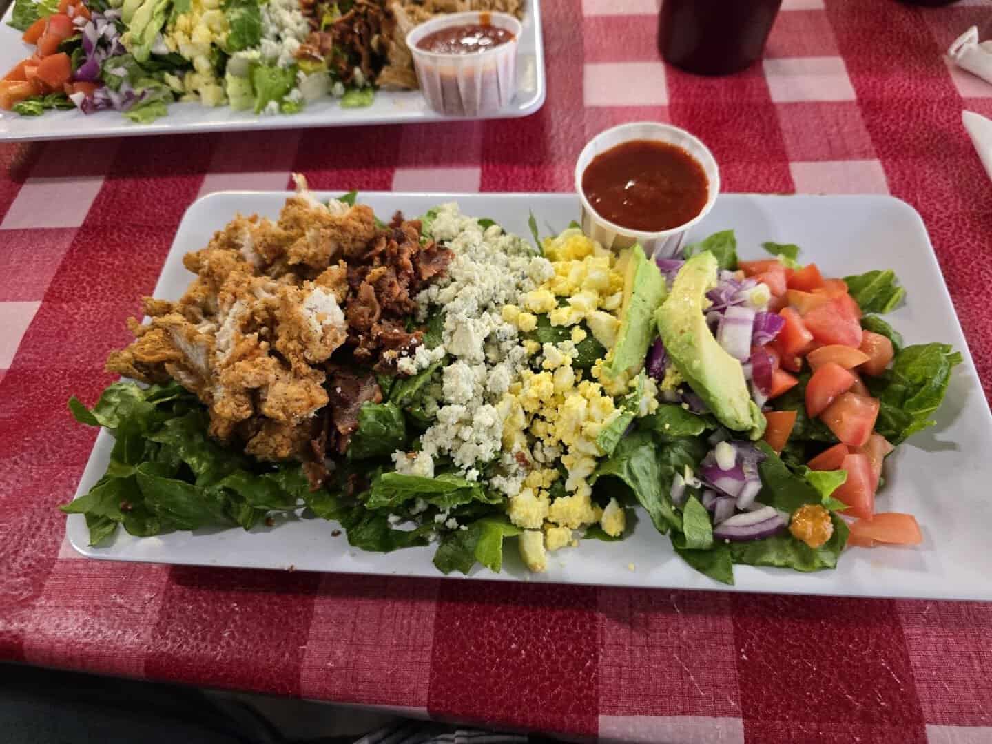 Fried appetizer platter beside a large house salad at Texan Cafe and Pie Shop in Hutto, Texas