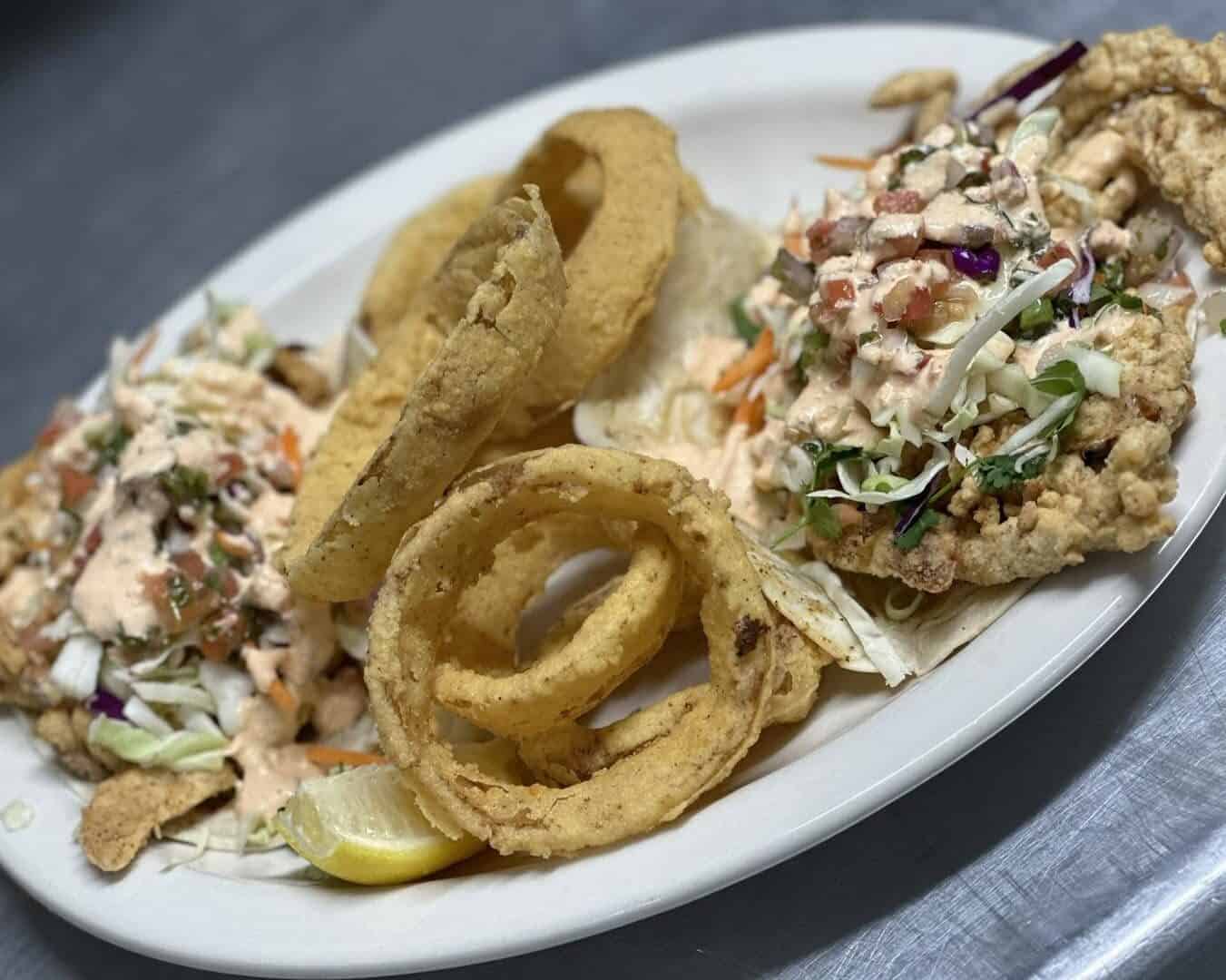 Fried seafood platter with onion rings at Stingaree in Crystal Beach, Texas