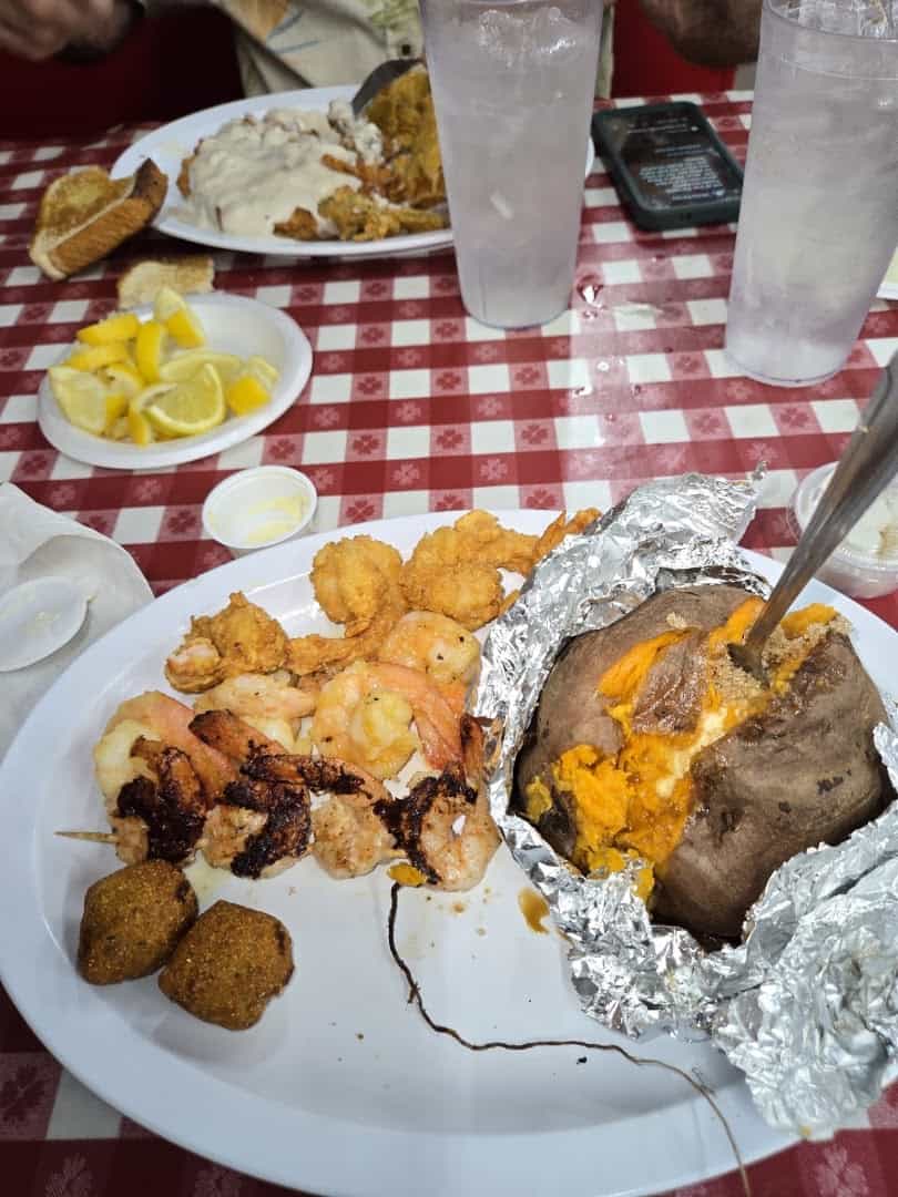 Fried shrimp with hush puppies and a baked sweet potato at the Farm House in Mexia, Texas