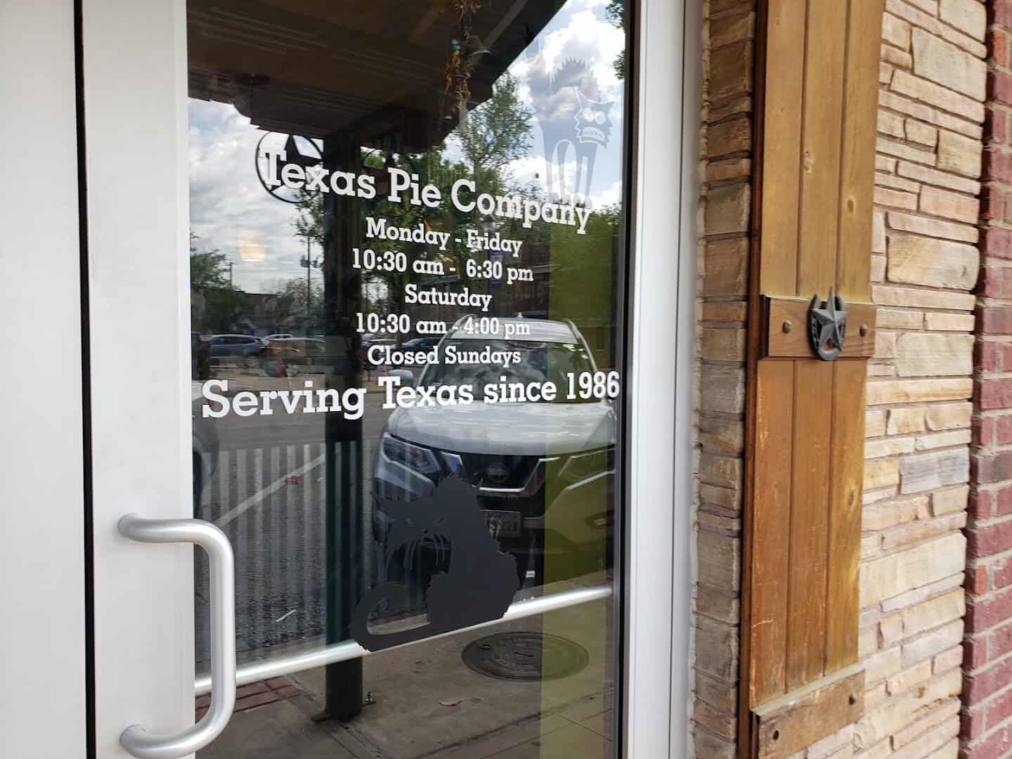 Front door decal reading Serving Texas since 1986 at Texas Pie Company in Kyle, Texas