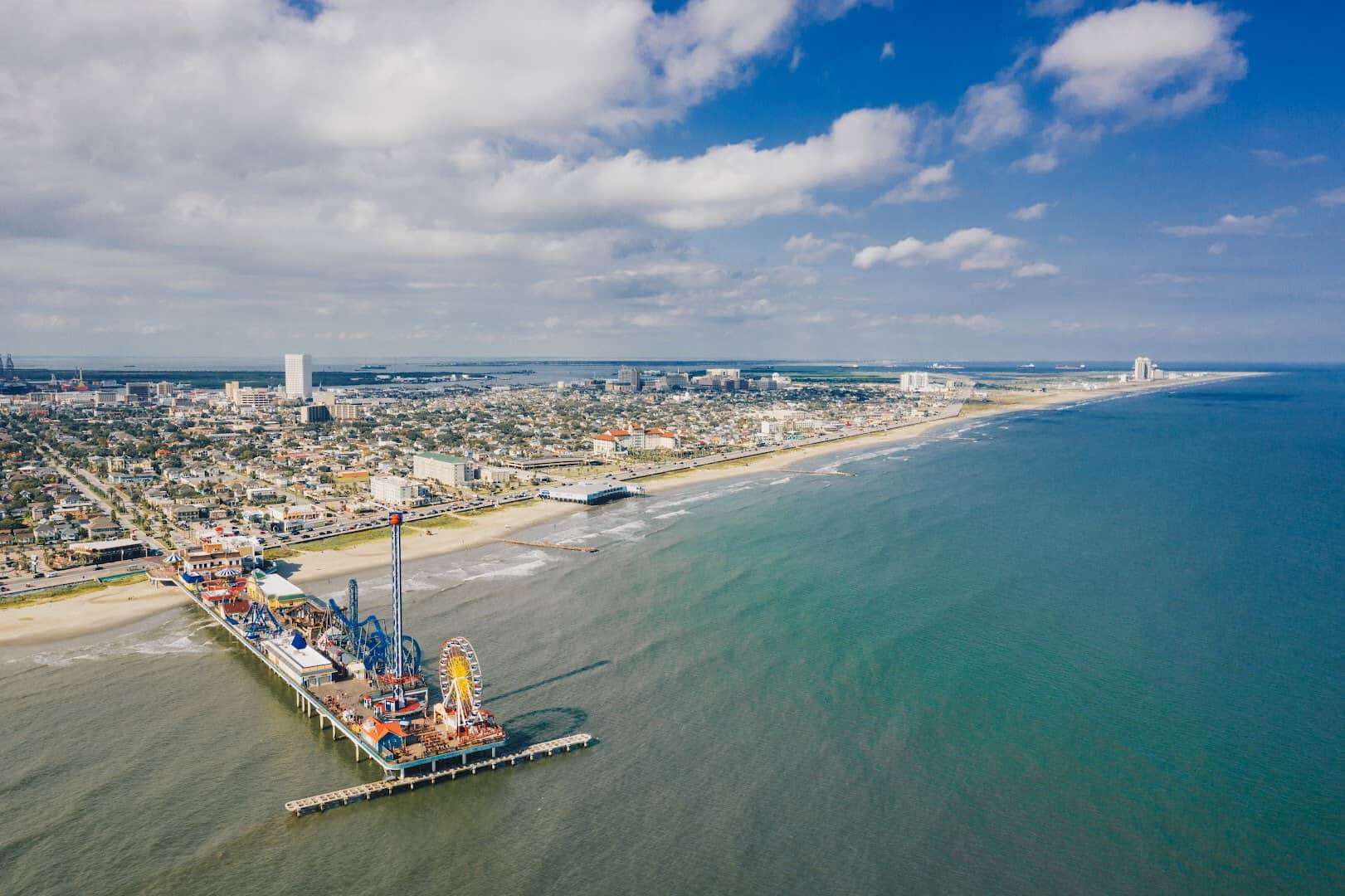 Aerial view of the Galveston Seawall, the beach and the Pleasure Pier in Galveston, Texas