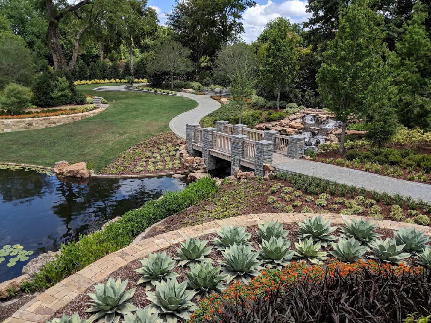 A garden path and wooden bridge at the Dallas Arboretum in Dallas