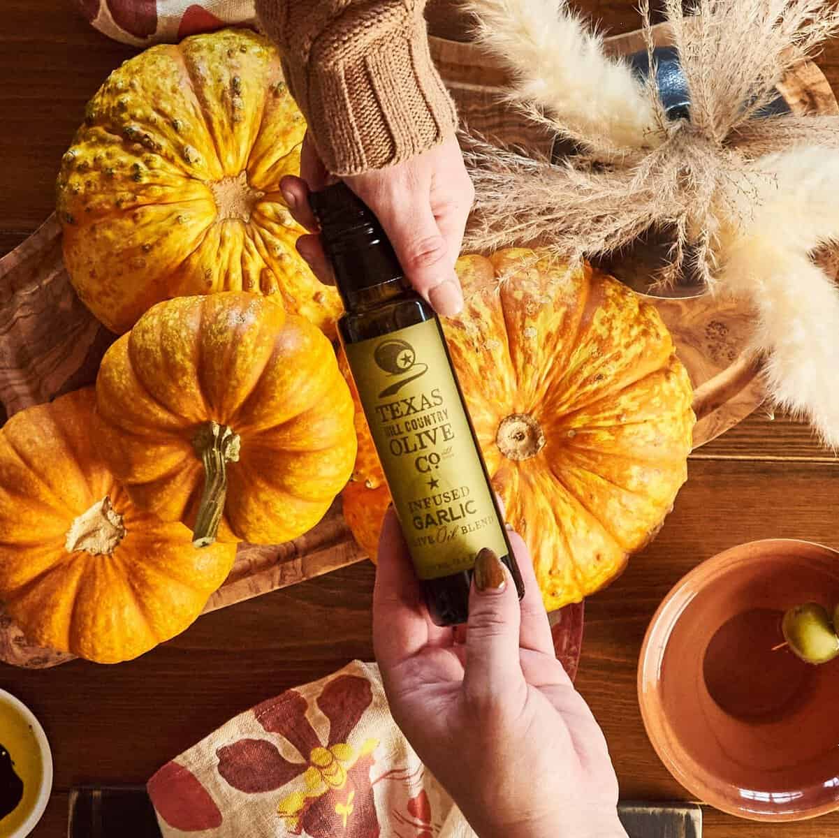 Texas Hill Country garlic infused olive oil with autumn gourds at harvest time