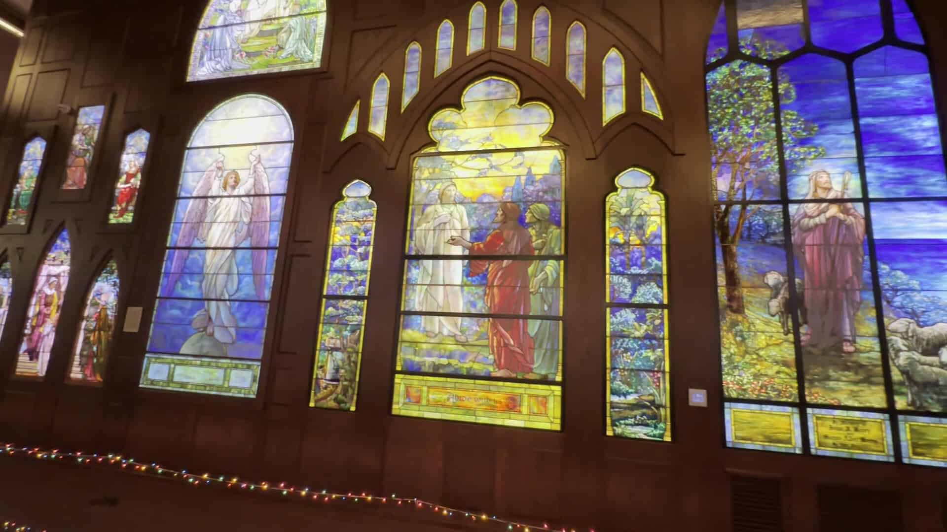 Row of vivid arched stained glass windows at the Gelman Stained Glass Museum