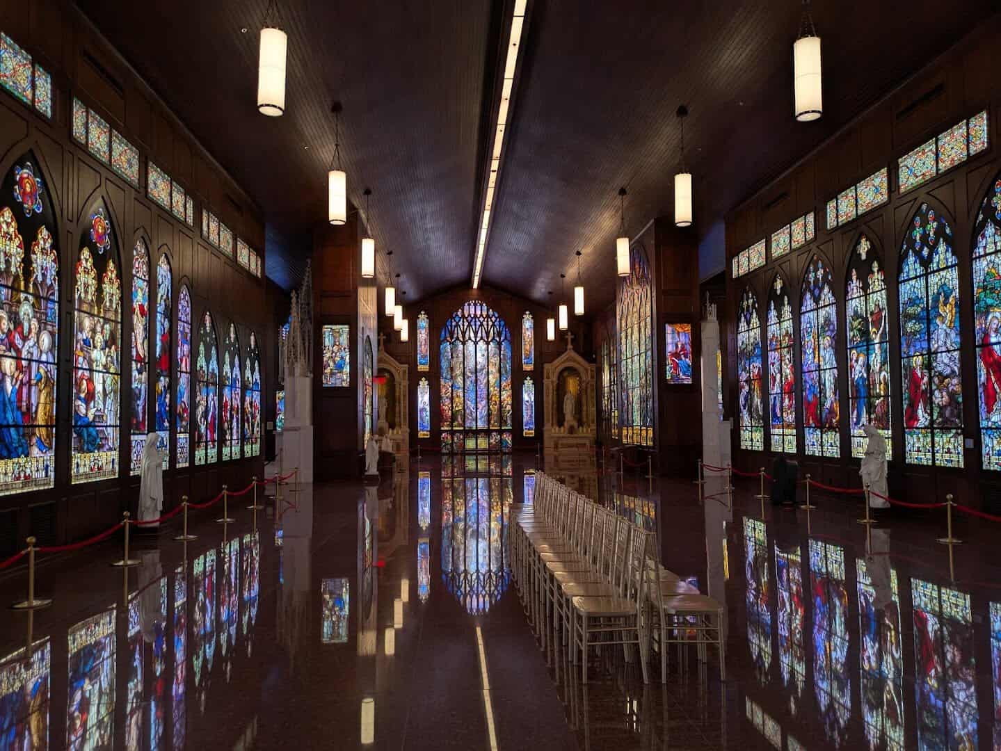 Gallery of stained glass windows with seating at the Gelman Stained Glass Museum