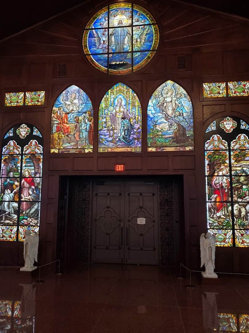 Backlit stained glass windows above a doorway at the Gelman Stained Glass Museum
