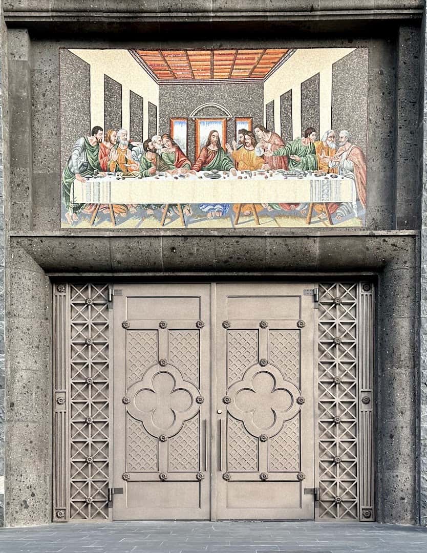A Last Supper artwork above ornate doors at the Gelman Stained Glass Museum