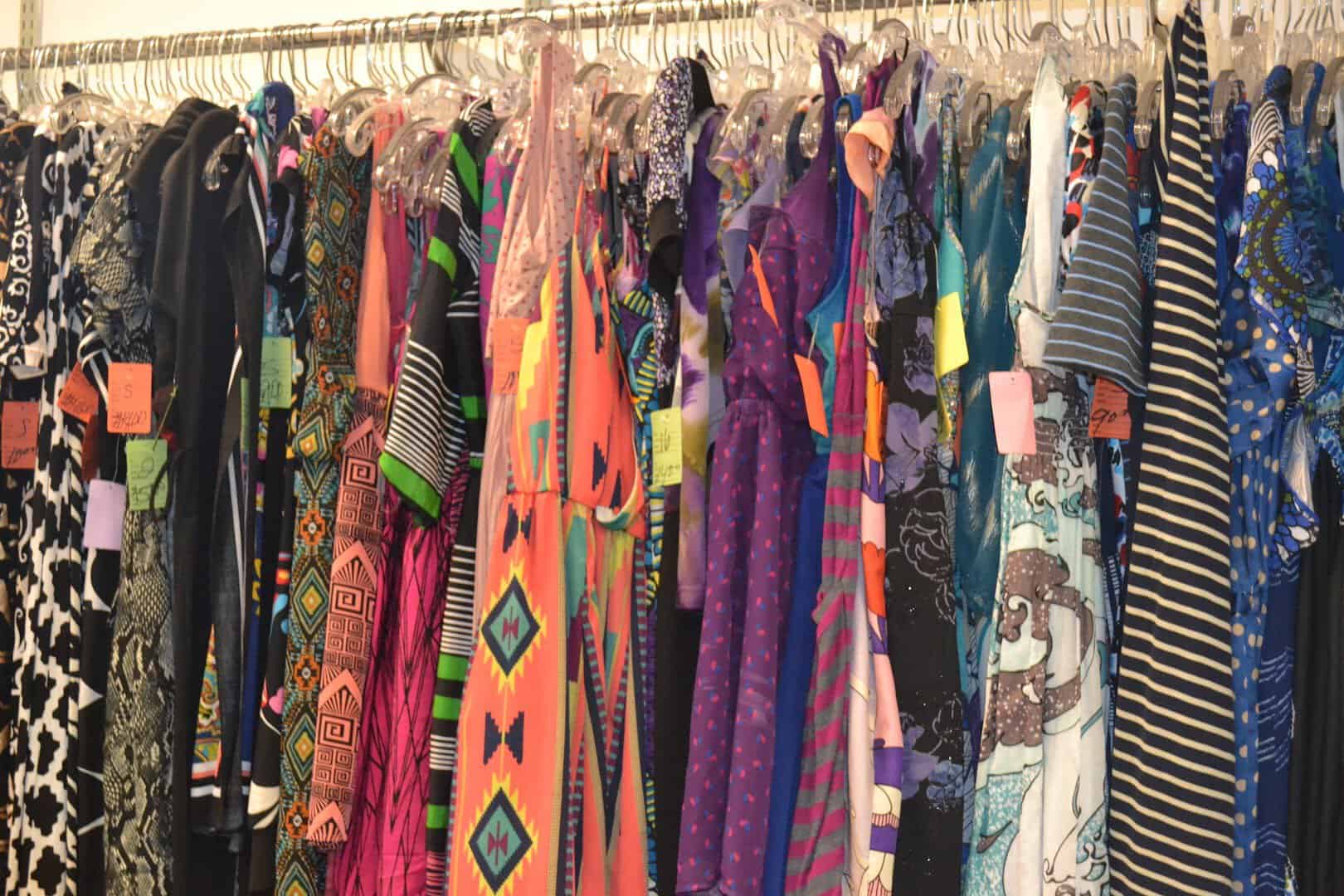 Colorful clothing racks at Genesis Benefit Thrift Store in Dallas, Texas