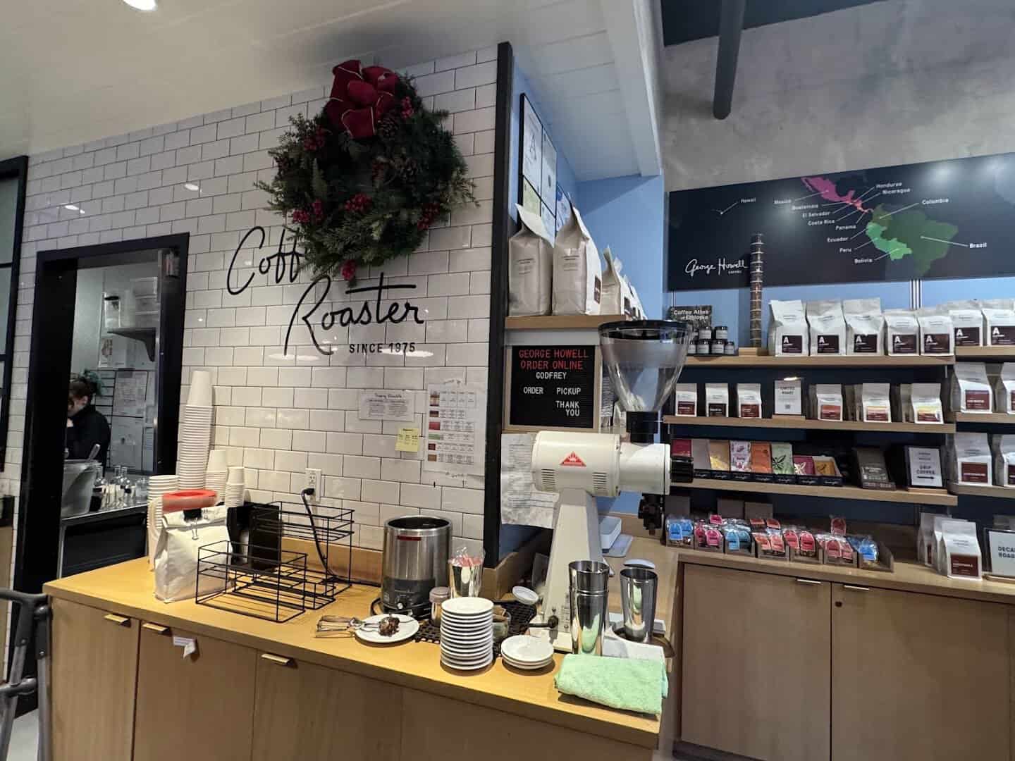 Coffee roaster counter with bags at George Howell Coffee in Boston