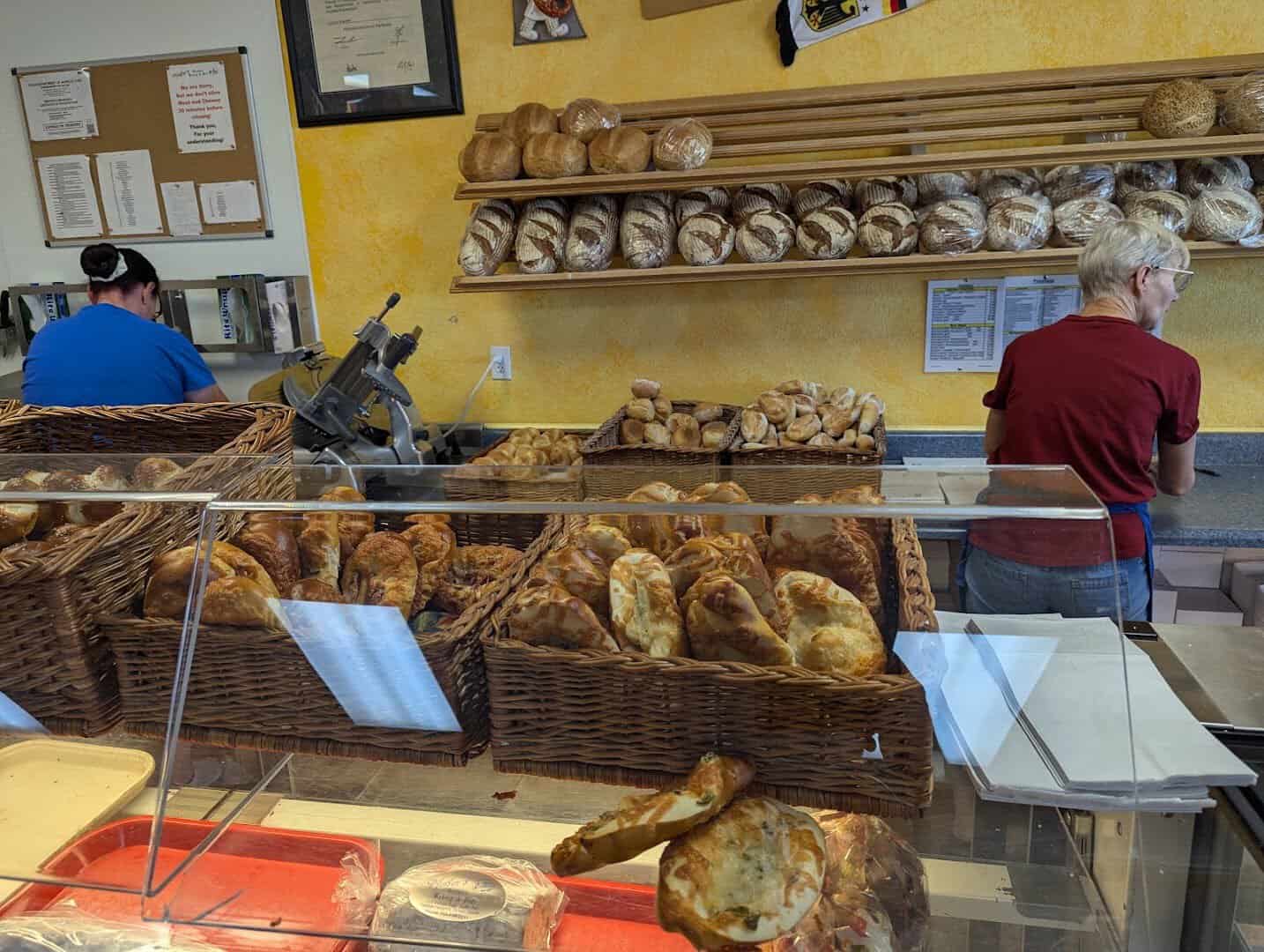 Display case of fresh-baked German bread loaves at Pfeifer's German Bakery in Harker Heights, Texas
