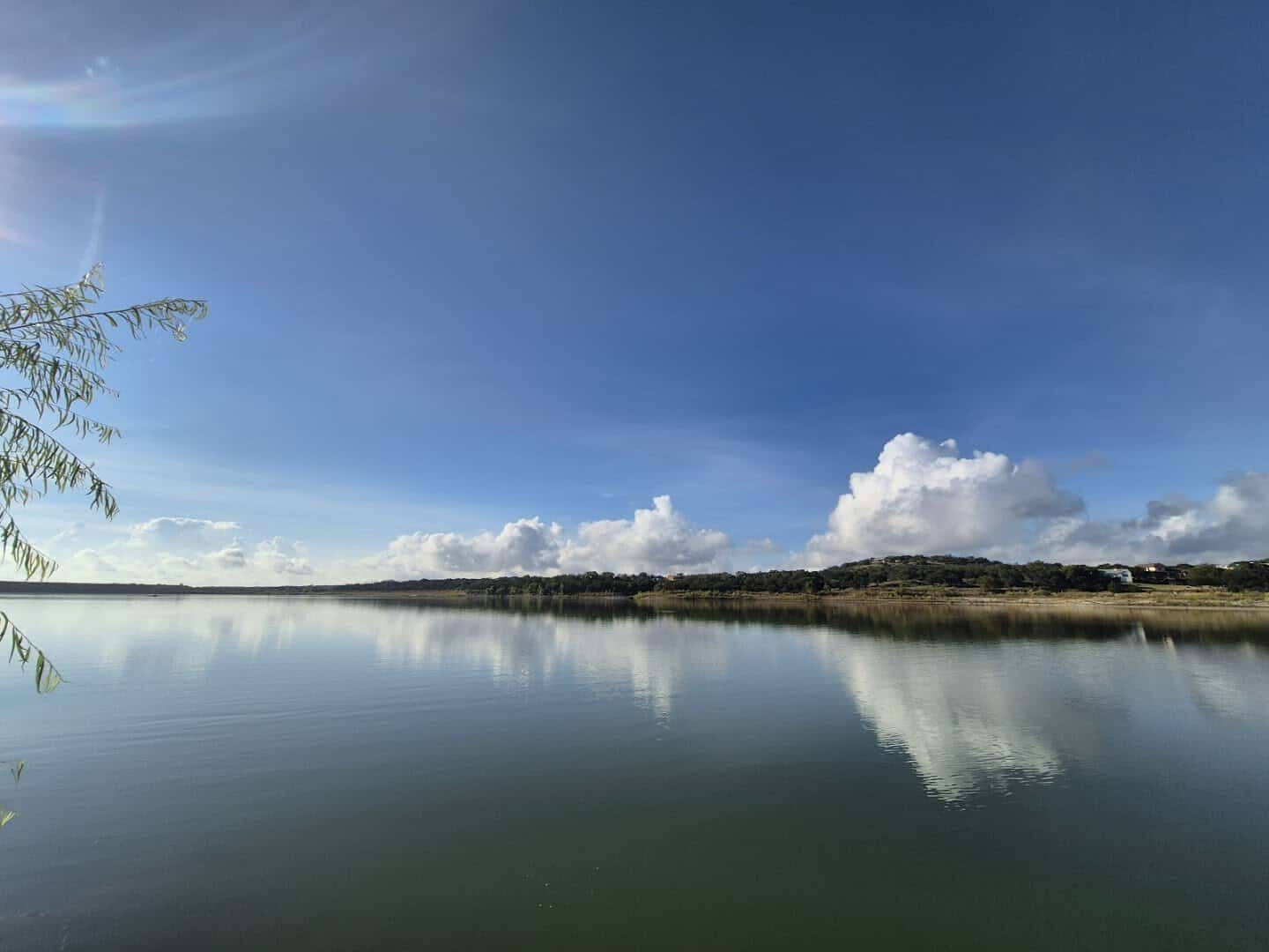 Glassy morning water and cloud reflections on Boerne City Lake