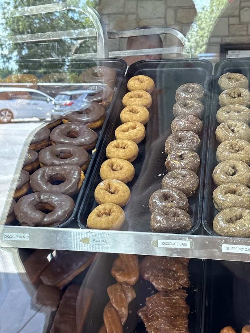 Glazed and chocolate covered donuts in the case at Round Rock Donuts in Round Rock, Texas