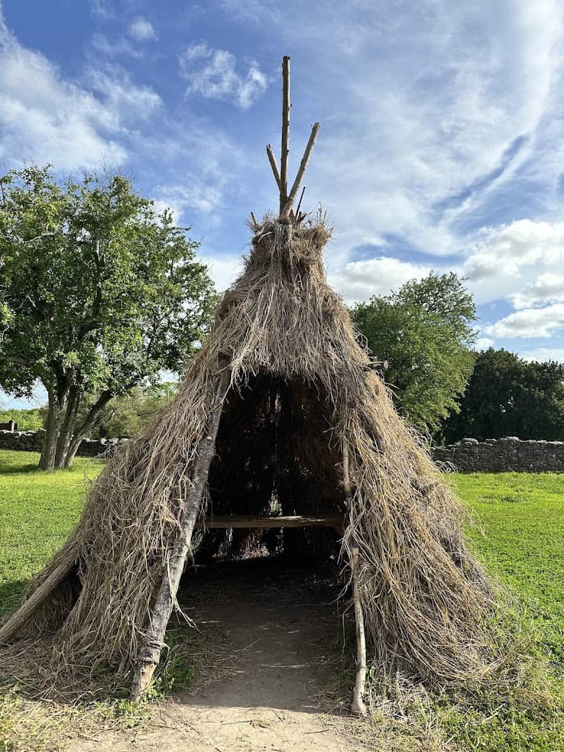 Reconstructed native grass shelter on the grounds of Goliad State Park, Texas