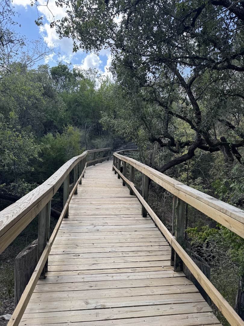 Wooden boardwalk over the river through the woods at Goliad State Park, Texas