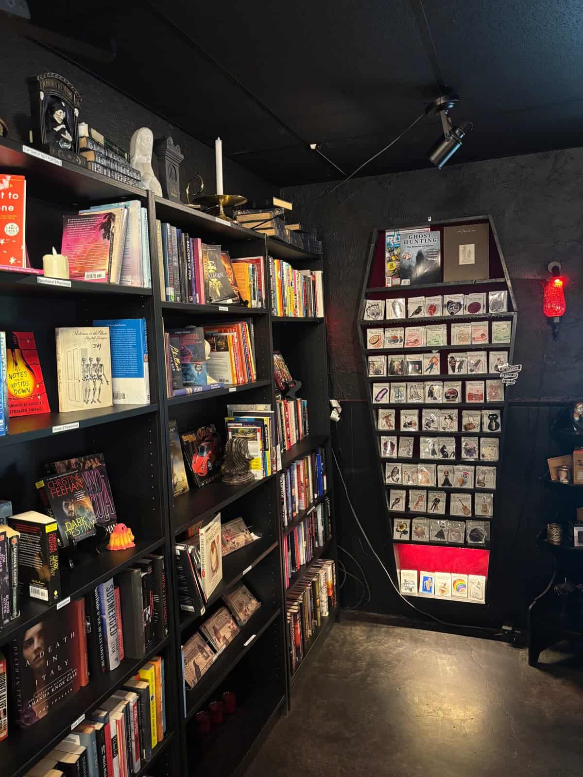 Bookstore shelves of horror and fantasy titles at Triple Six Social in San Marcos