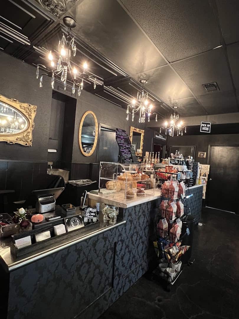 Gothic interior counter and pastry case under a chandelier at Triple Six Social in San Marcos