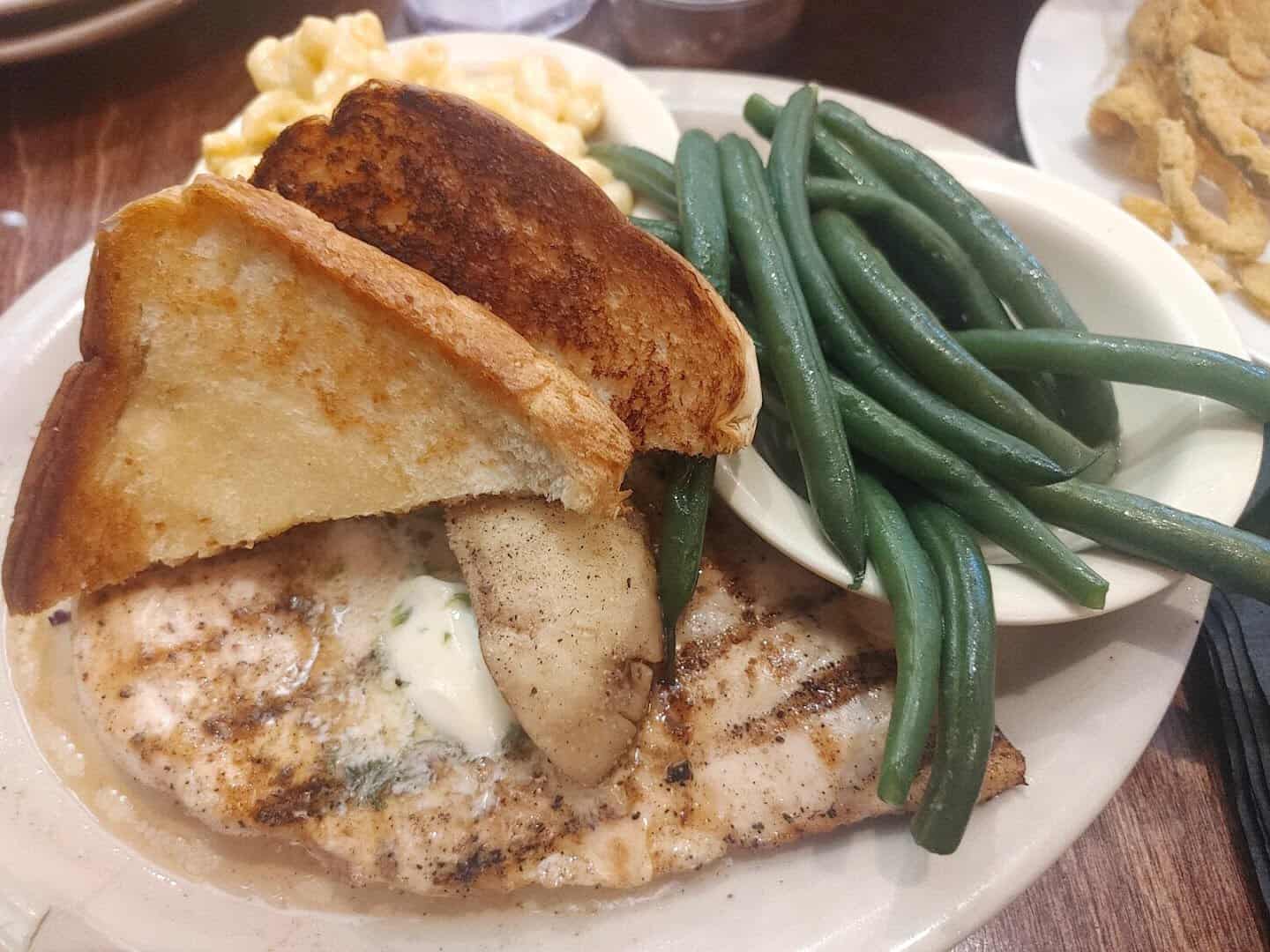 Grilled chicken breast with herb butter, green beans, mac and cheese and Texas toast at Richter's Antler Cafe in Spring Branch, Texas