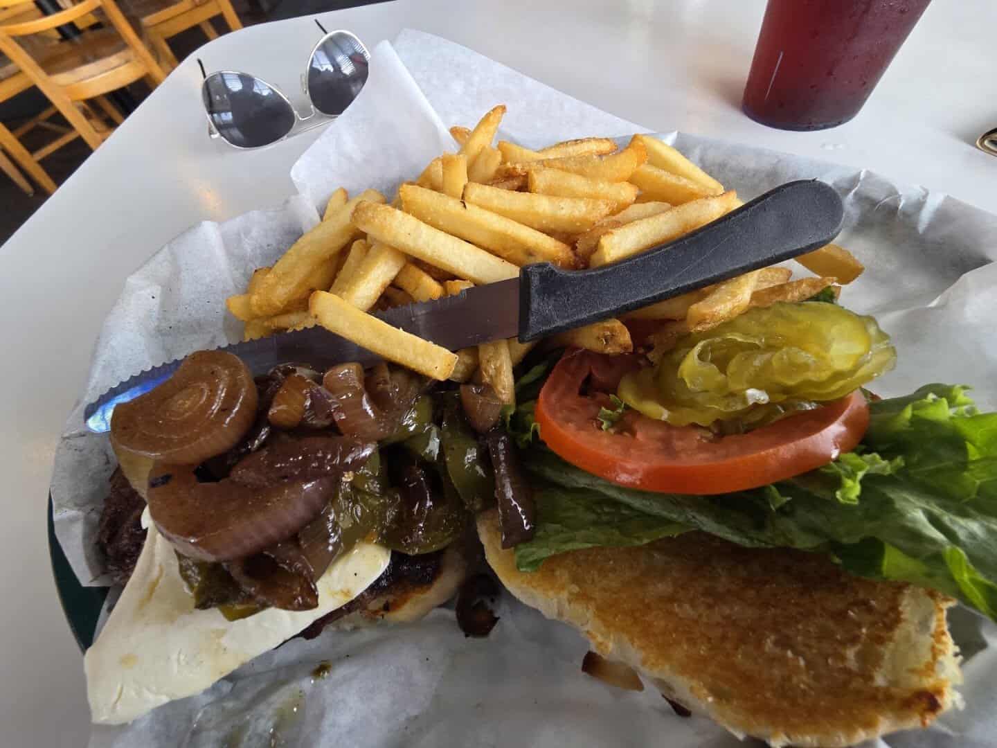Loaded burger with grilled jalapenos and onions and fries at Roadhouse in Bastrop, Texas