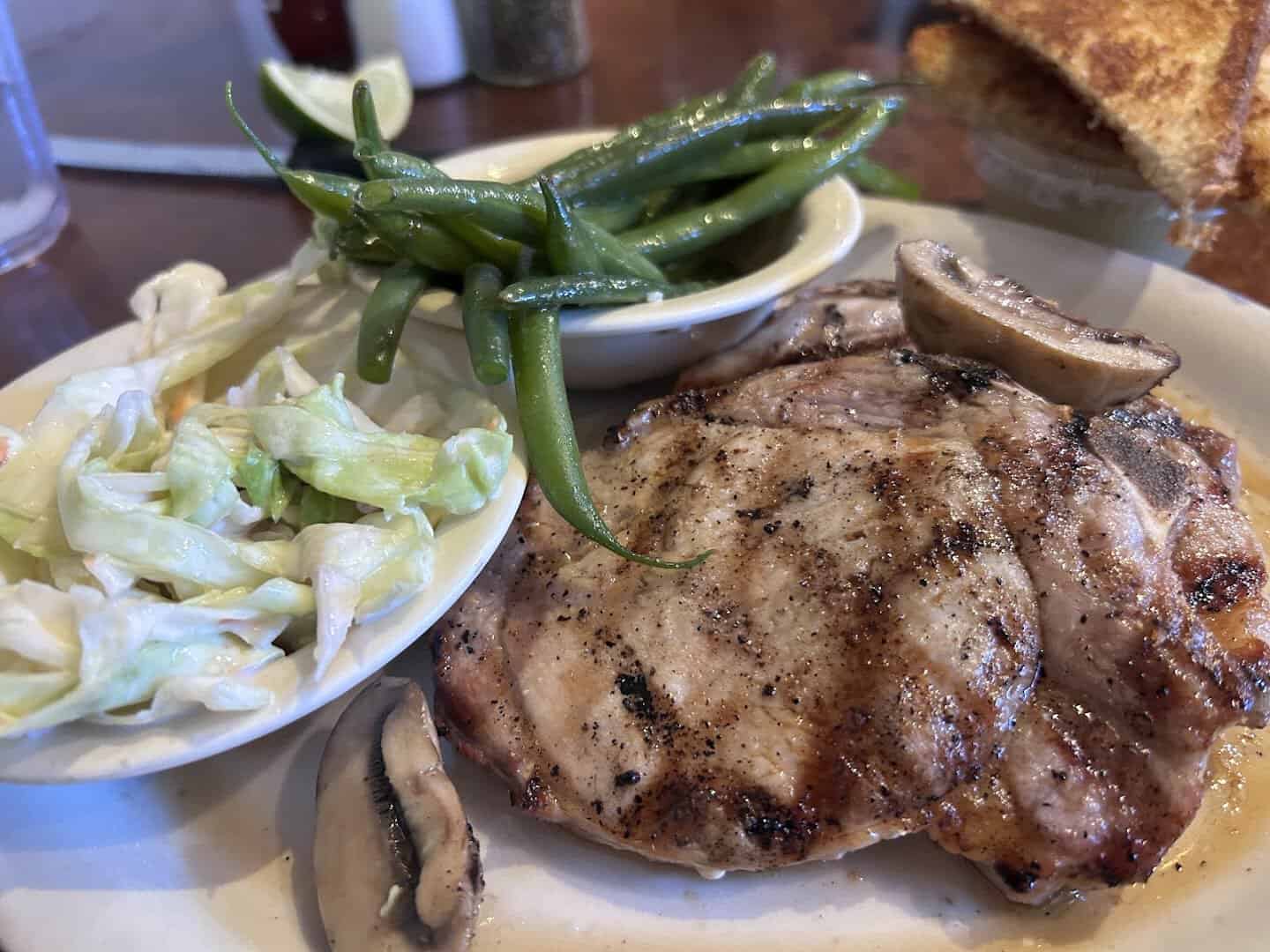 Grilled pork chop plate with green beans, coleslaw and Texas toast at Richter's Antler Cafe in Spring Branch, Texas