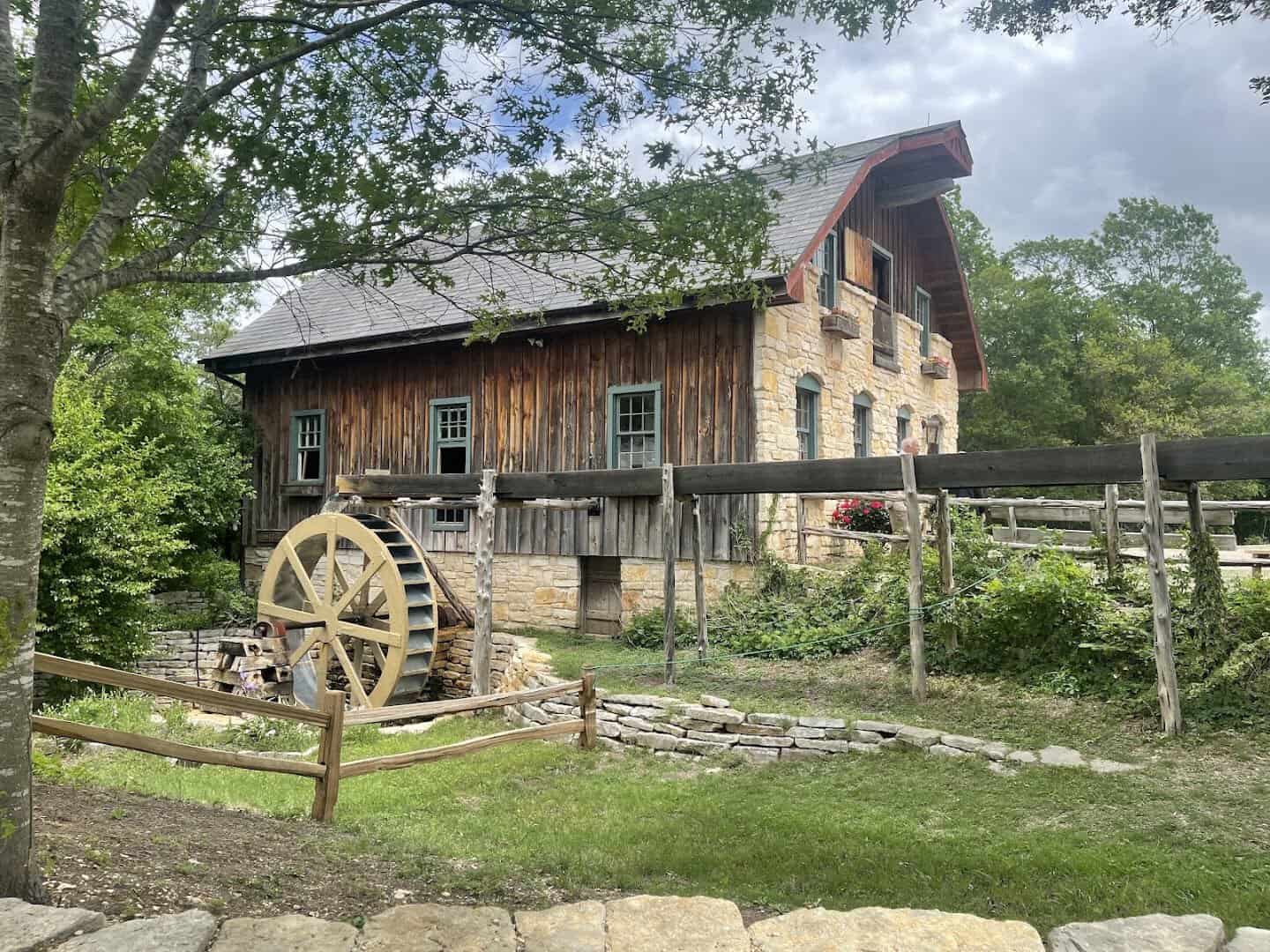 Restored 1760 gristmill with waterwheel at Homestead Heritage near Waco, Texas