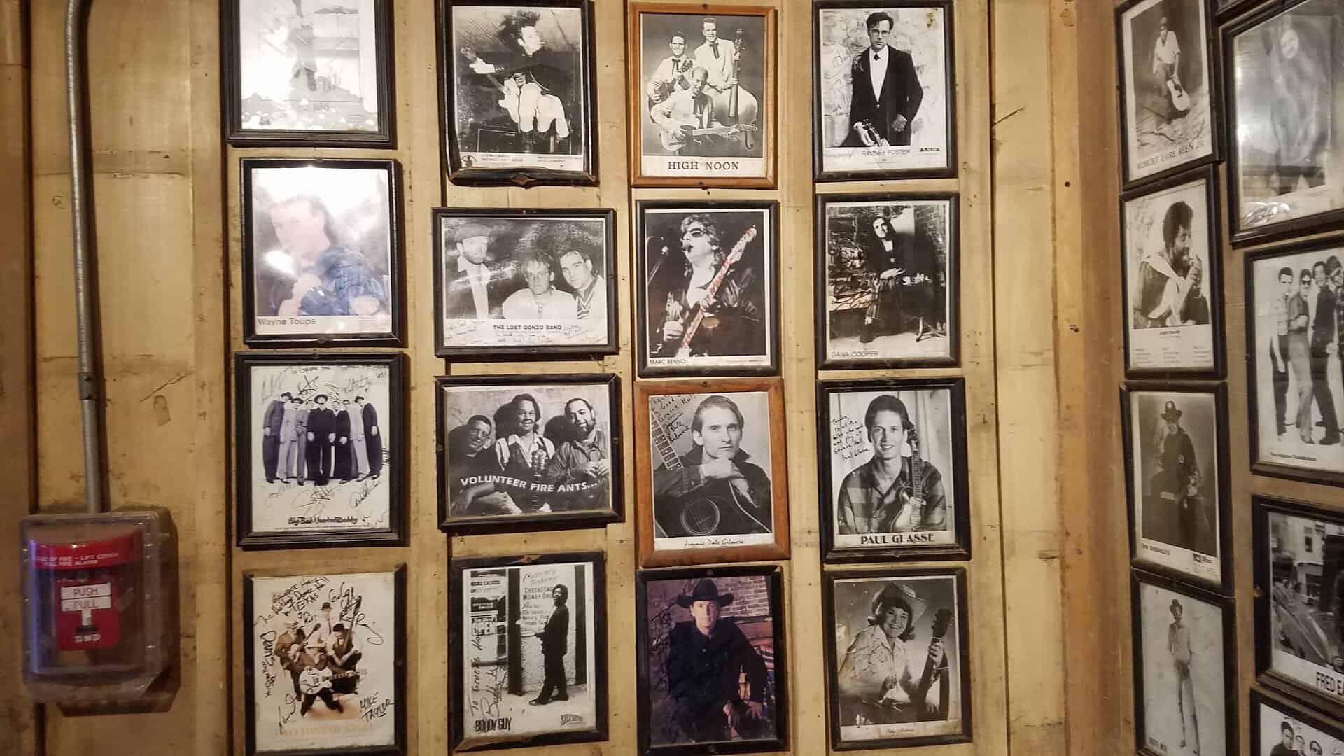 Wall of framed photos of musicians who played Gruene Hall in Texas