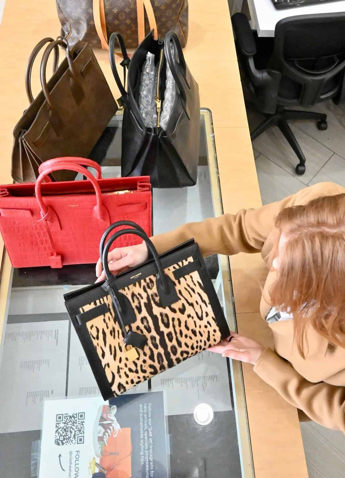 Designer handbags being inspected and authenticated at Clotheshorse Anonymous in Dallas
