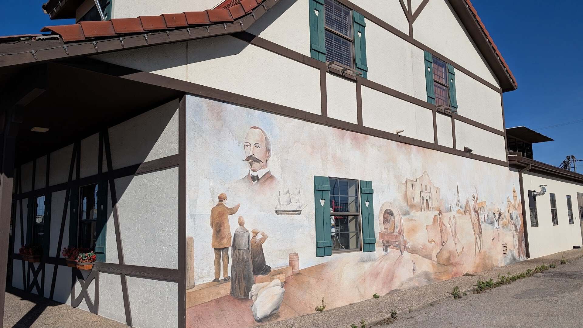 Mural of town founder Henri Castro on a wall in Castroville, Texas