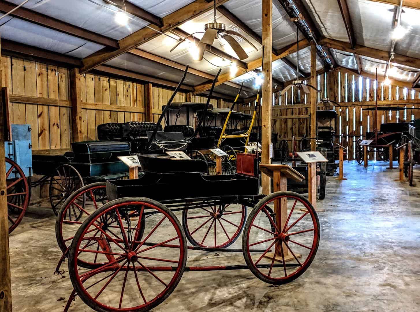 Pioneer carriages in a barn at Heritage Village in Woodville, Texas