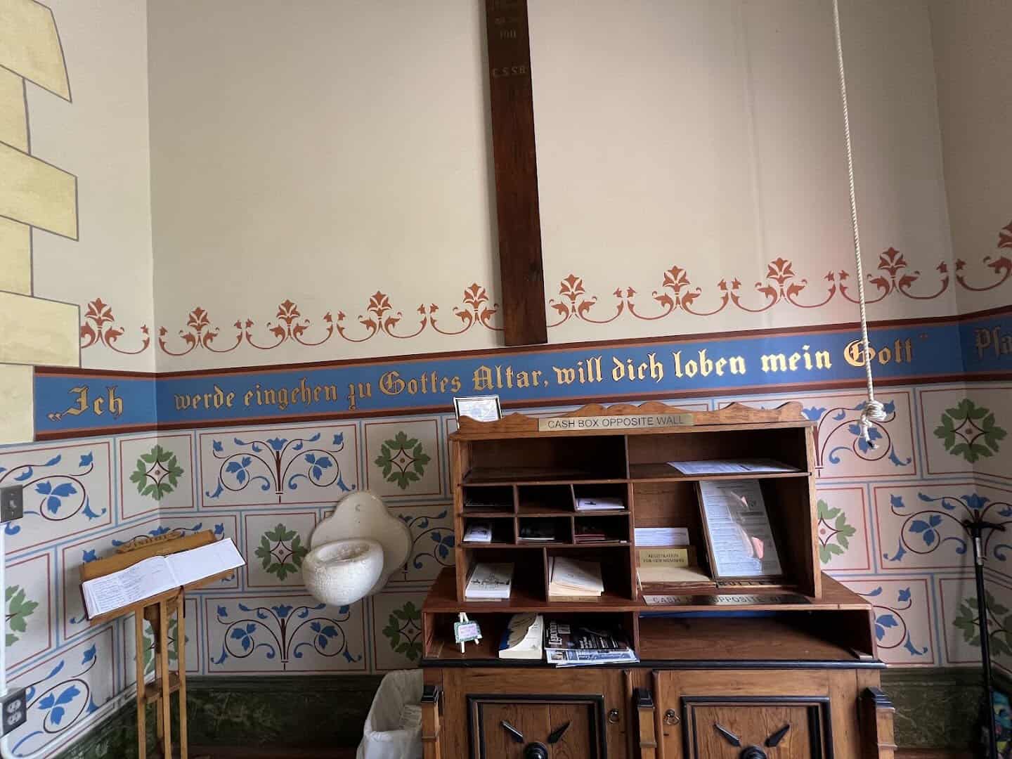 German inscription and painted stenciling on a wall inside the High Hill church