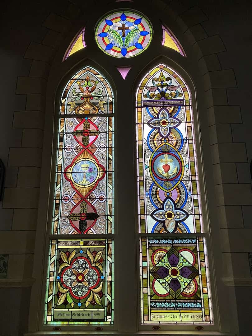 Stained-glass lancet and rose windows in the High Hill painted church