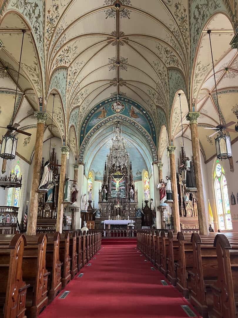 Painted interior of St. Mary's Catholic Church in High Hill, Texas, looking down the aisle to the altar