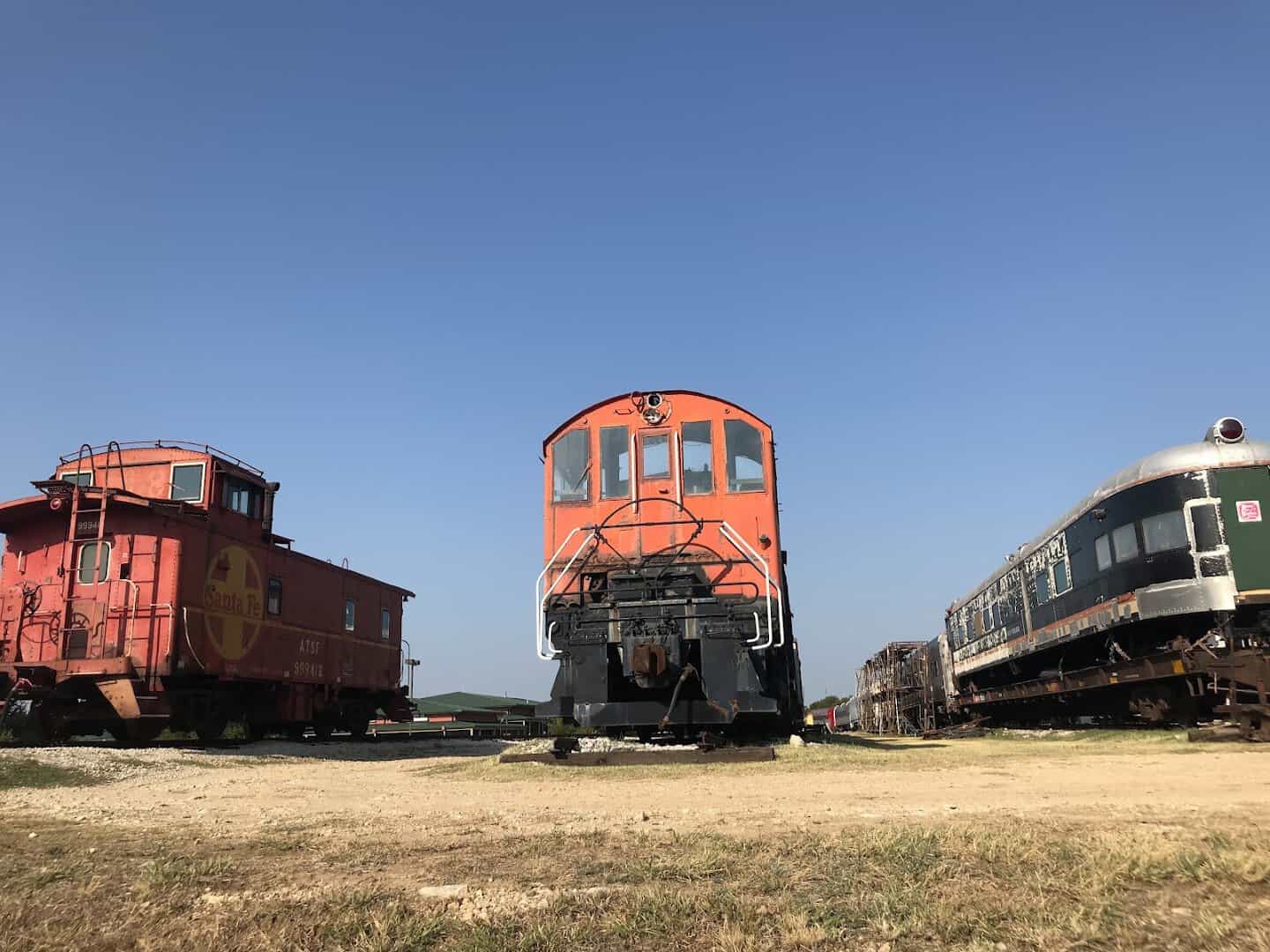Vintage caboose and passenger cars of the Austin Steam Train in the open Texas Hill Country