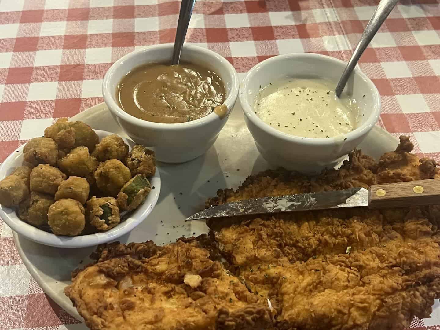 Fried okra and gravy served alongside chicken fried steak at Hofbrau Steaks in Porter, Texas