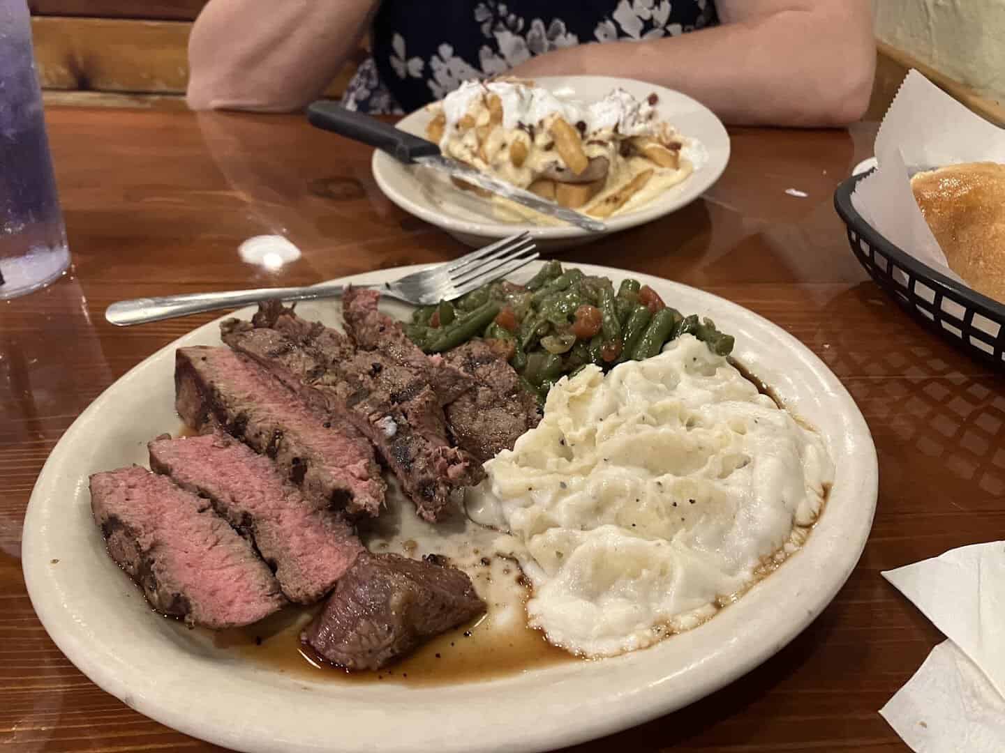 Sliced steak with mashed potatoes at Hofbrau Steaks in Porter, Texas