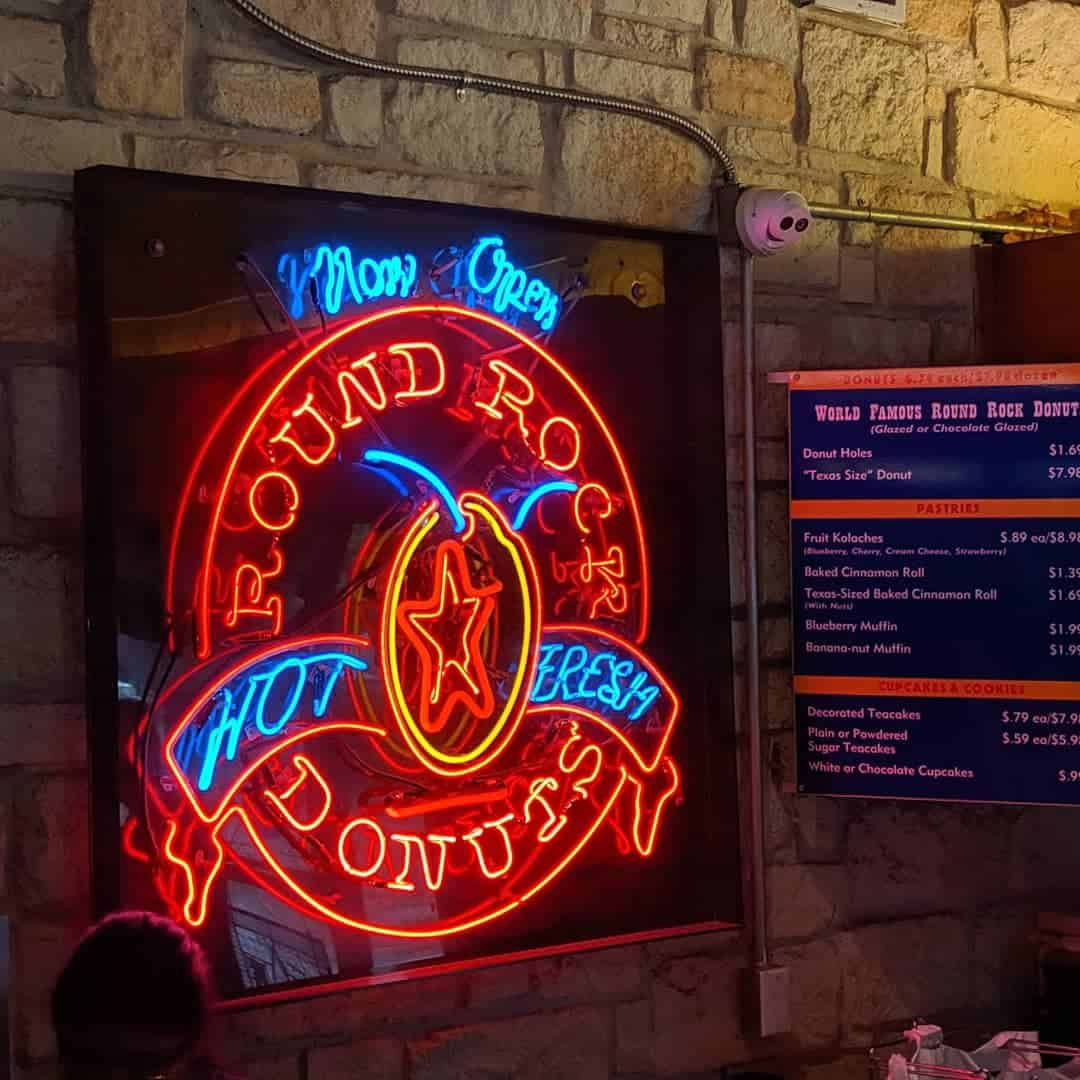 Neon Round Rock Donuts Hot Fresh sign inside the bakery in Round Rock, Texas