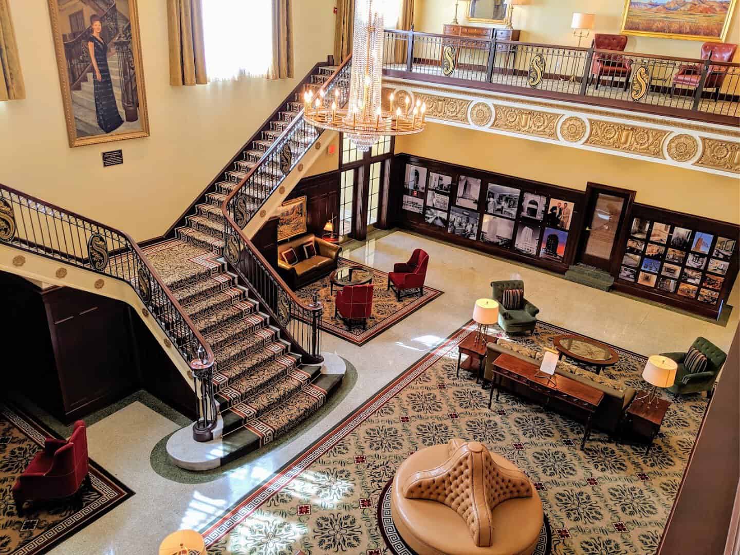 The grand double marble staircase and mezzanine in the lobby of Hotel Settles in Big Spring, Texas