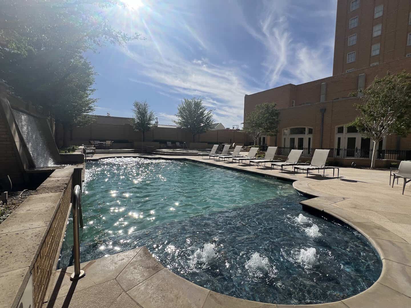 The outdoor pool with the Hotel Settles tower rising behind it in Big Spring, Texas