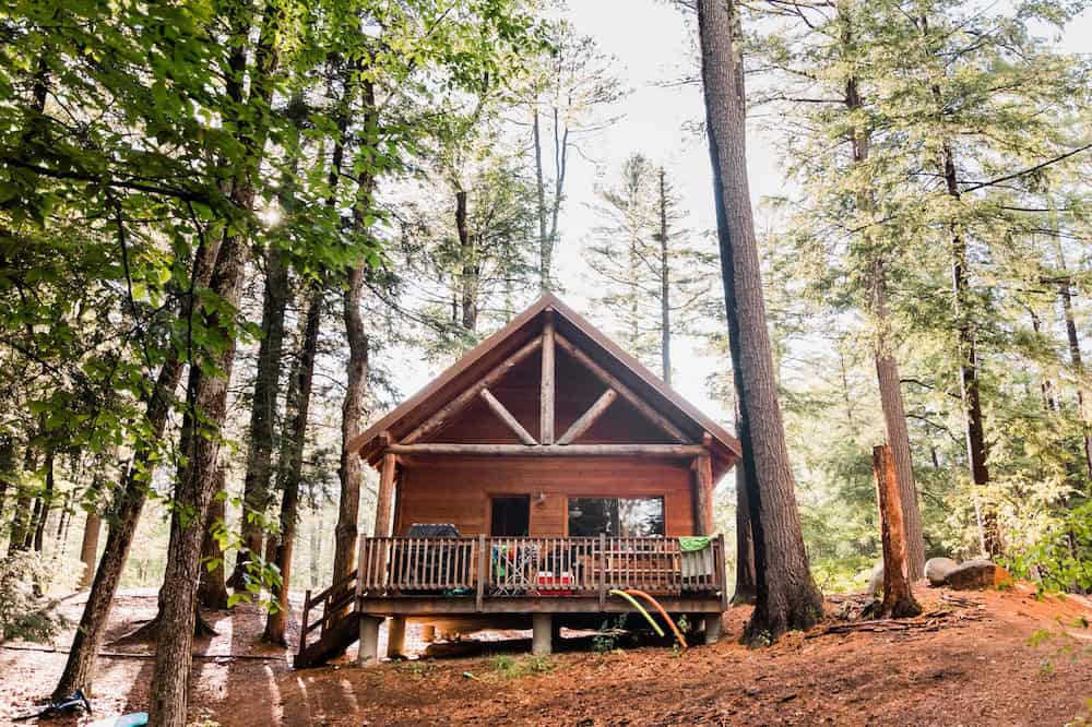 A wood and canvas cabin among the trees at Huttopia White Mountains, Albany, New Hampshire
