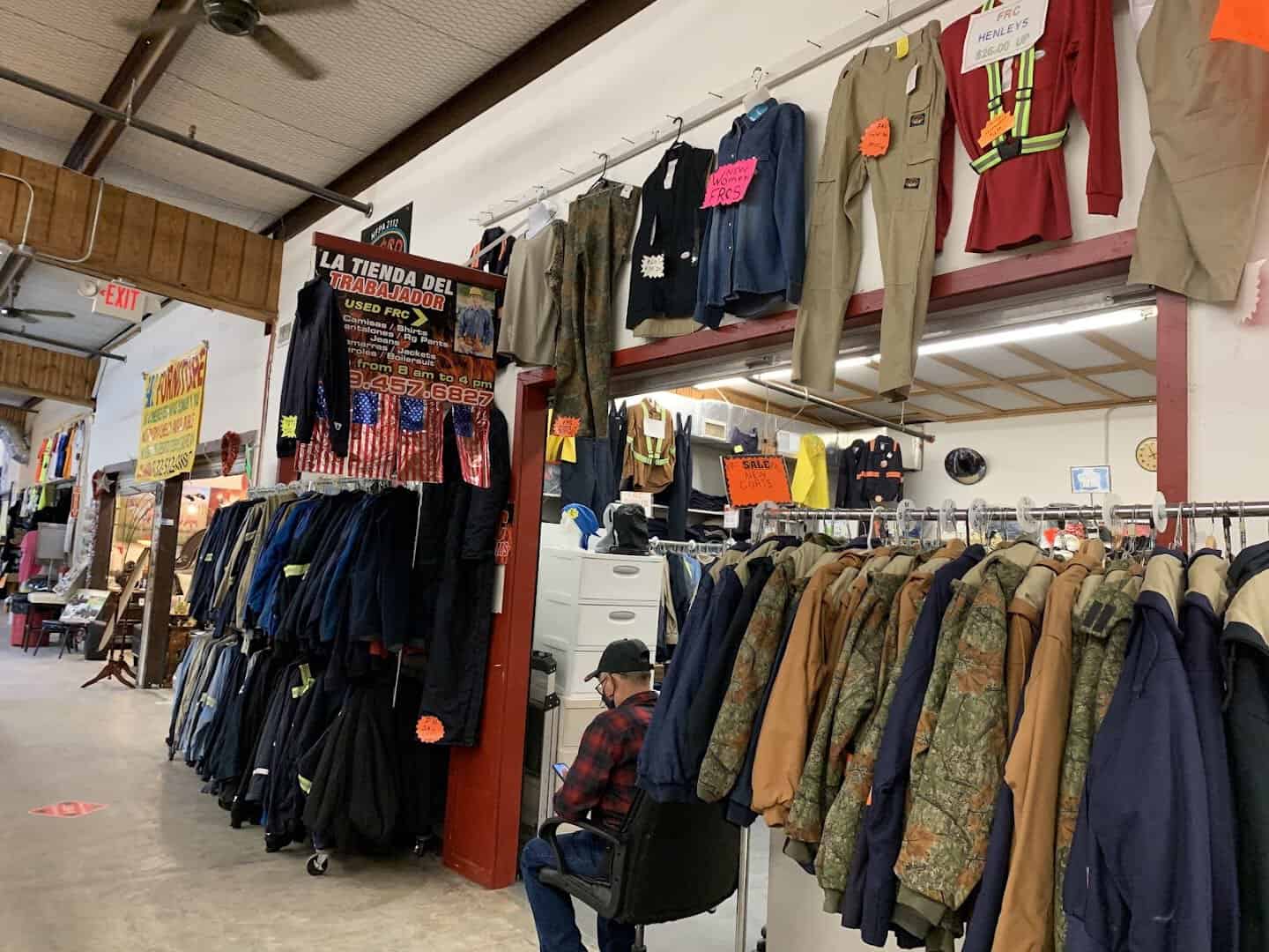 Racks of clothing filling one of the indoor buildings at Cole's Antique Village in Pearland, Texas